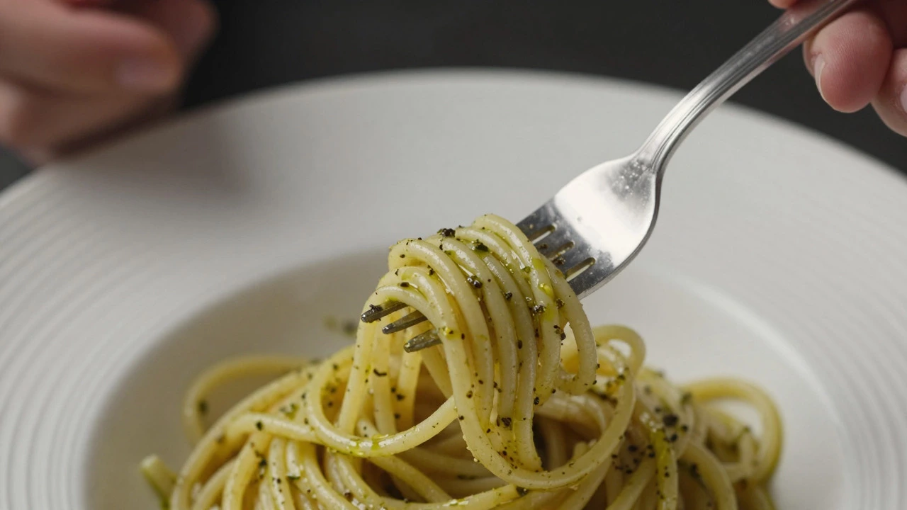 Hand using only a fork to twirl linguine on a plate